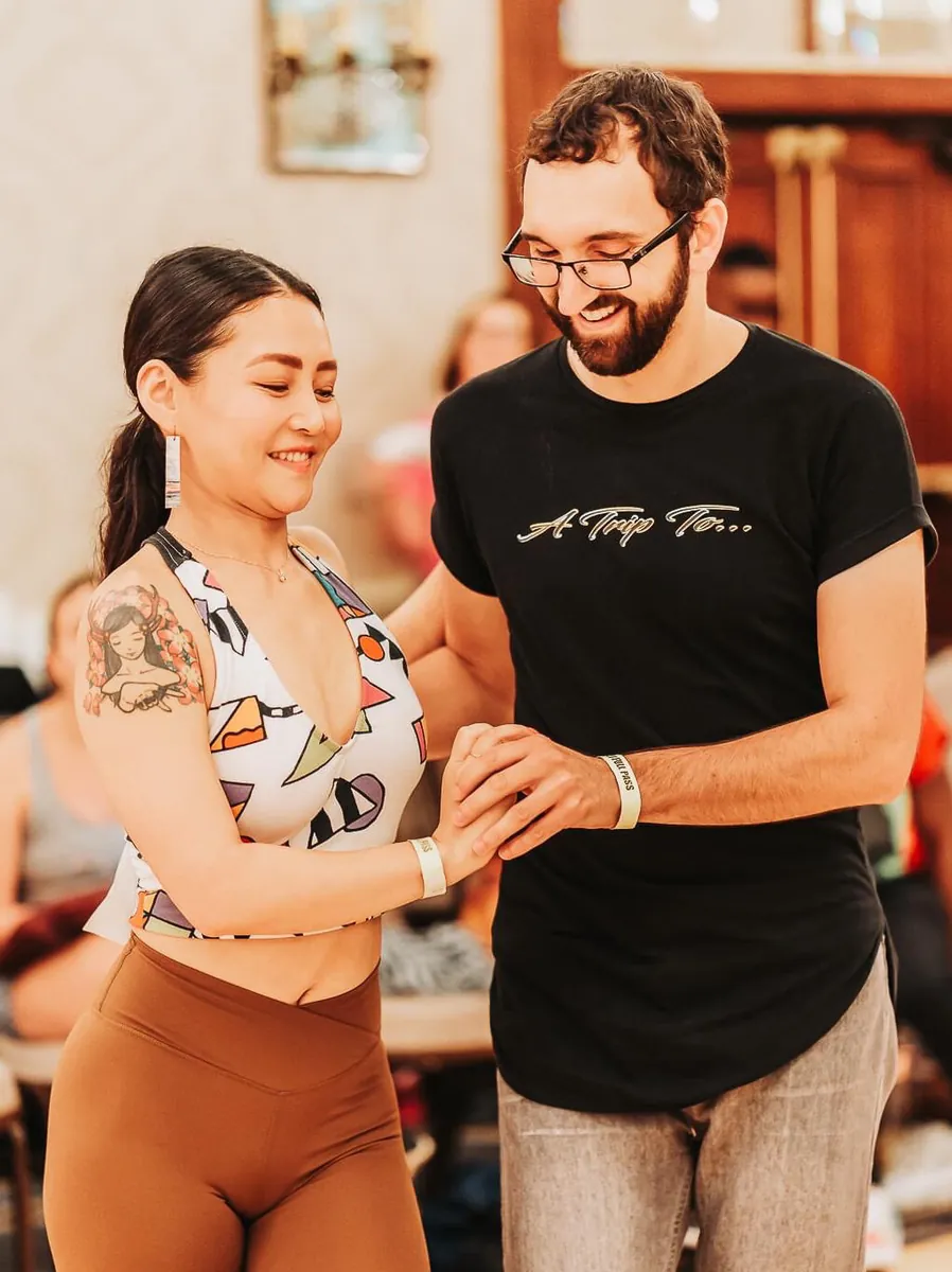 Two dancers in an Urban Kiz hold, smiling