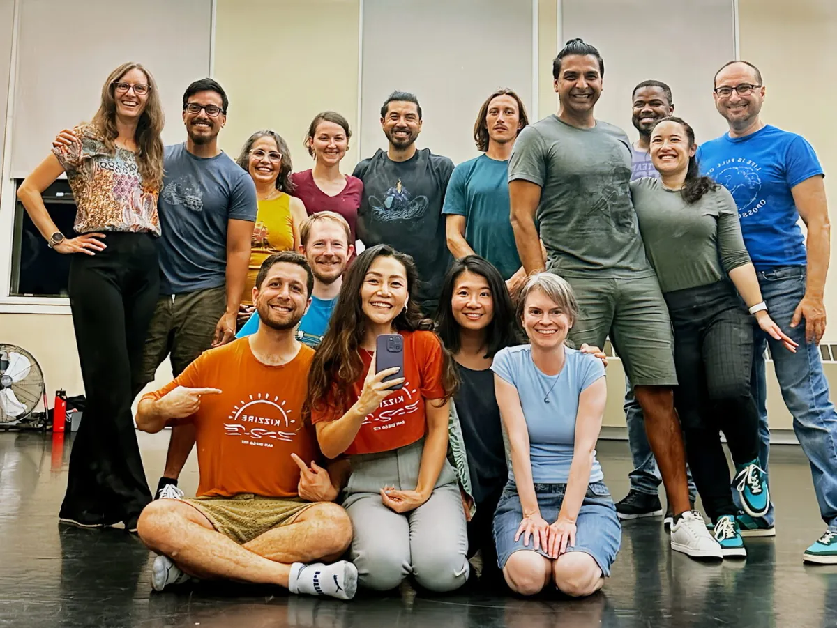 A Kizzire group class gathered for a photo in the studio