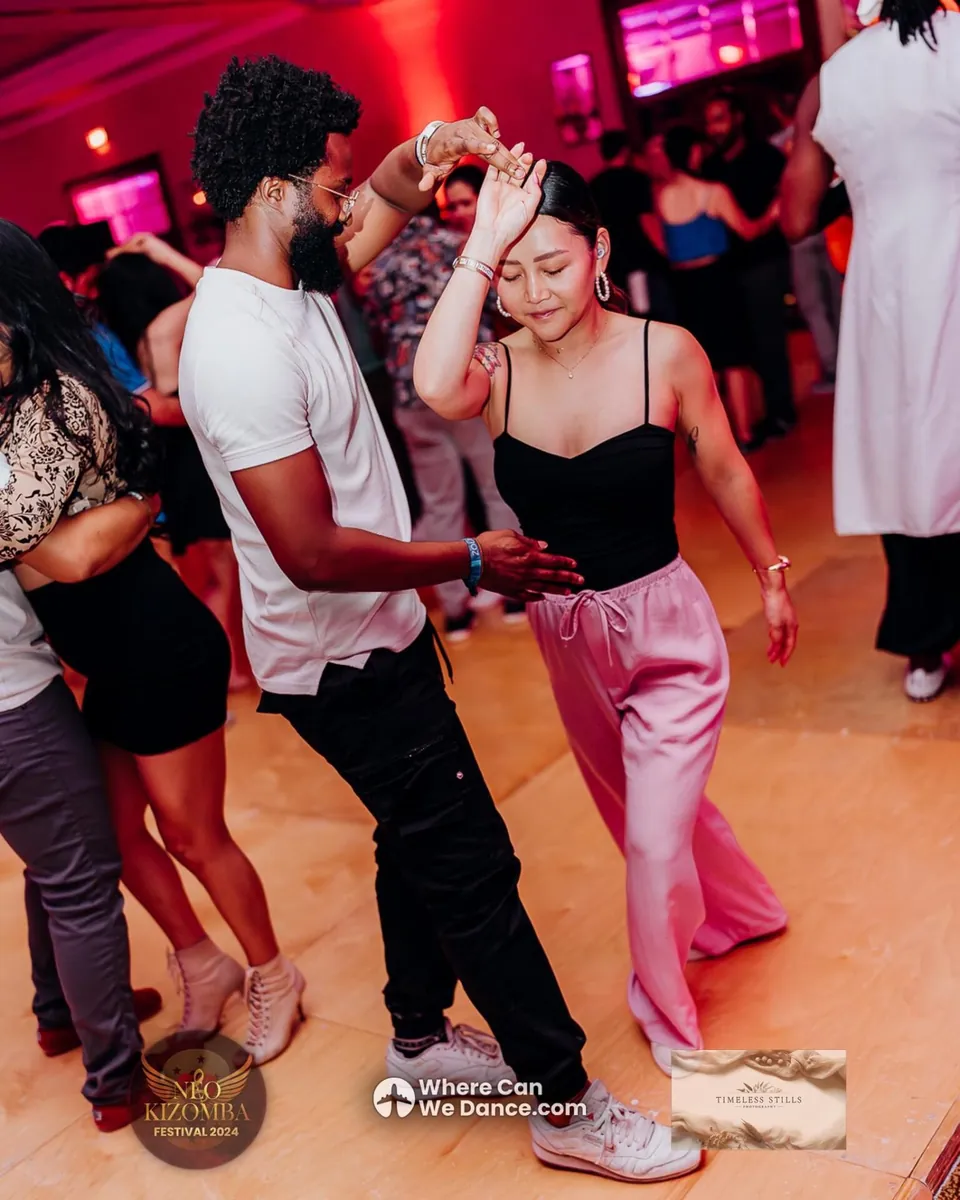 A couple dancing Urban Kiz under red party lights